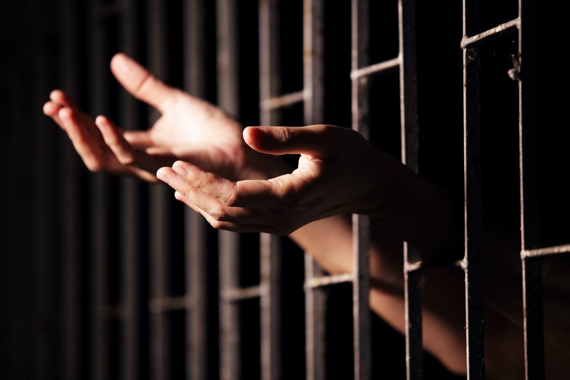 hands of prisoner in jail.